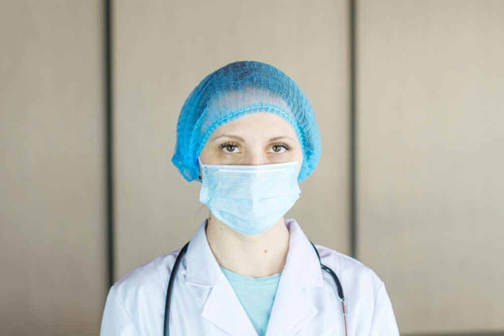 eine Ärztin mit einer blauen OP-Maske